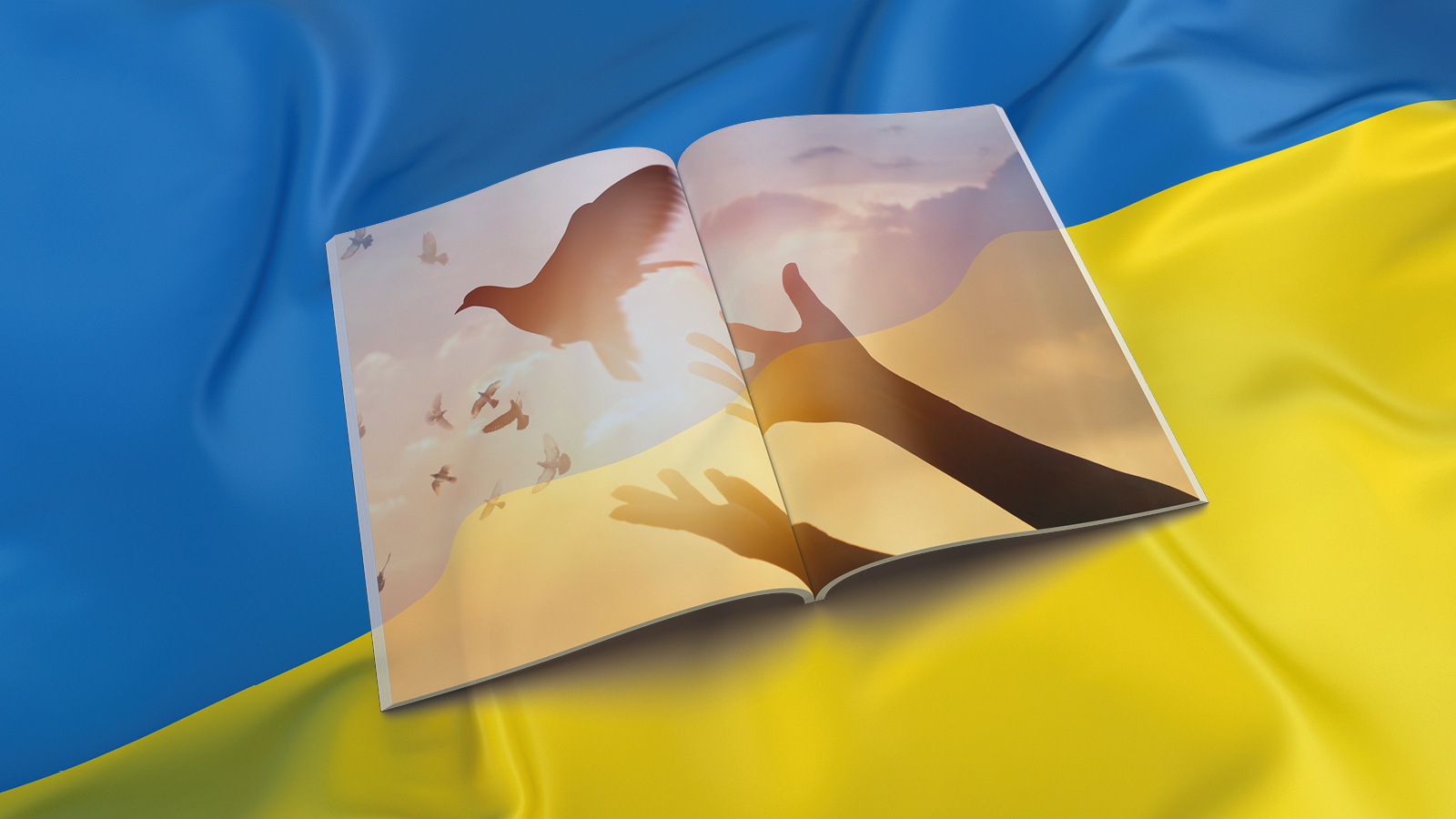 Avoin aikakauslehti Ukrainan lipun päällä.